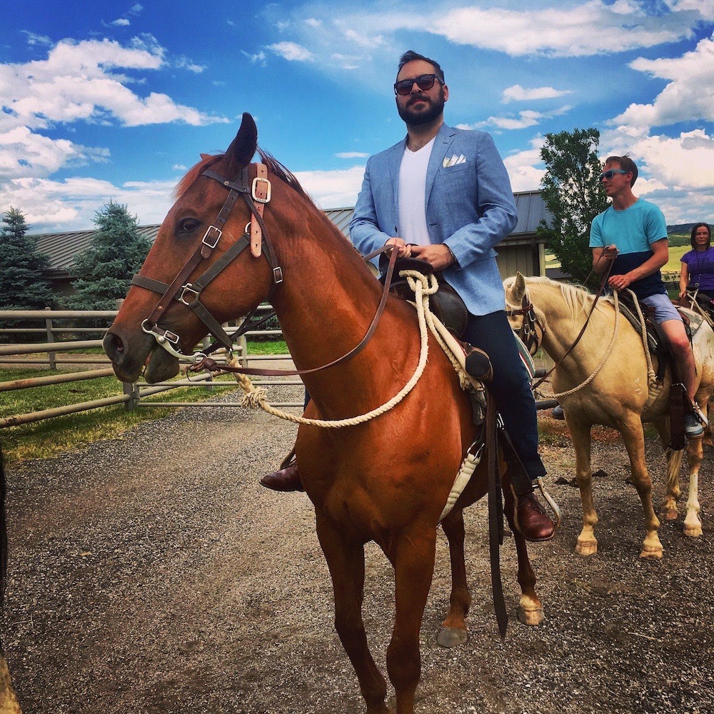 A photo of me on a horse looking quite dapper